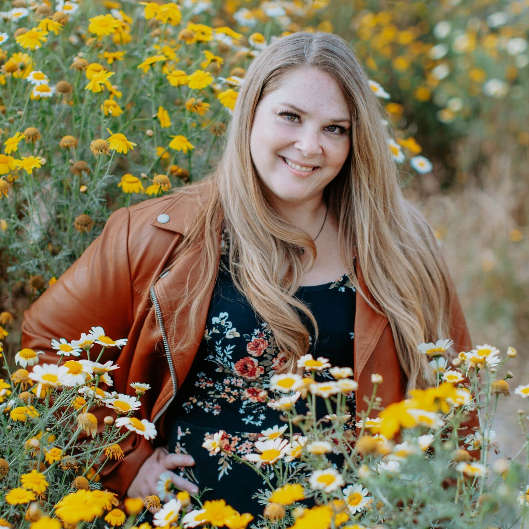 Robin Dayley surrounded by flowers