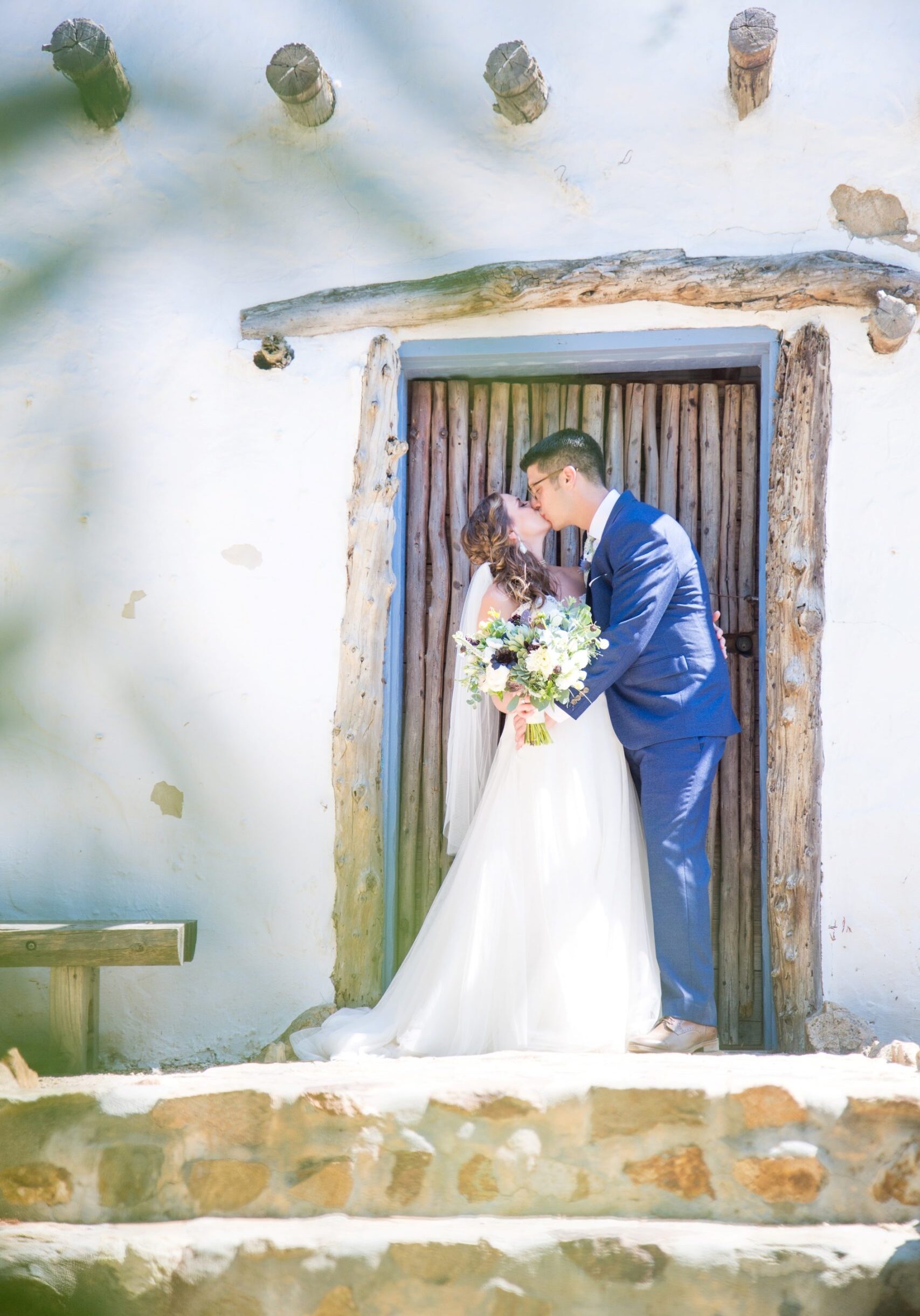 Bride and groom sharing a sweet and memorable kiss.