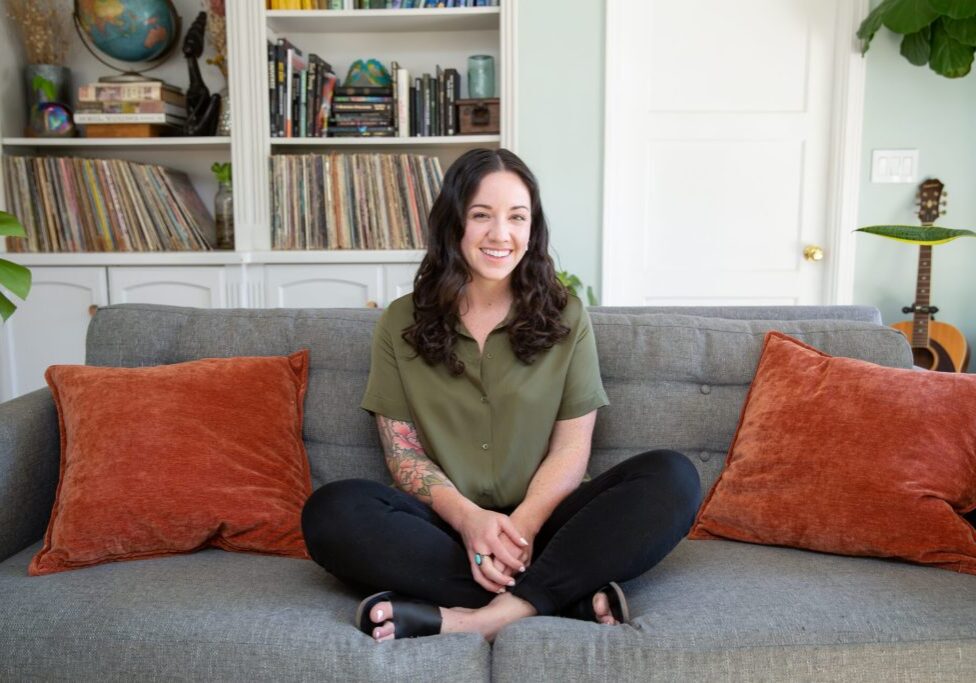 Lady smiling and sitting on a couch